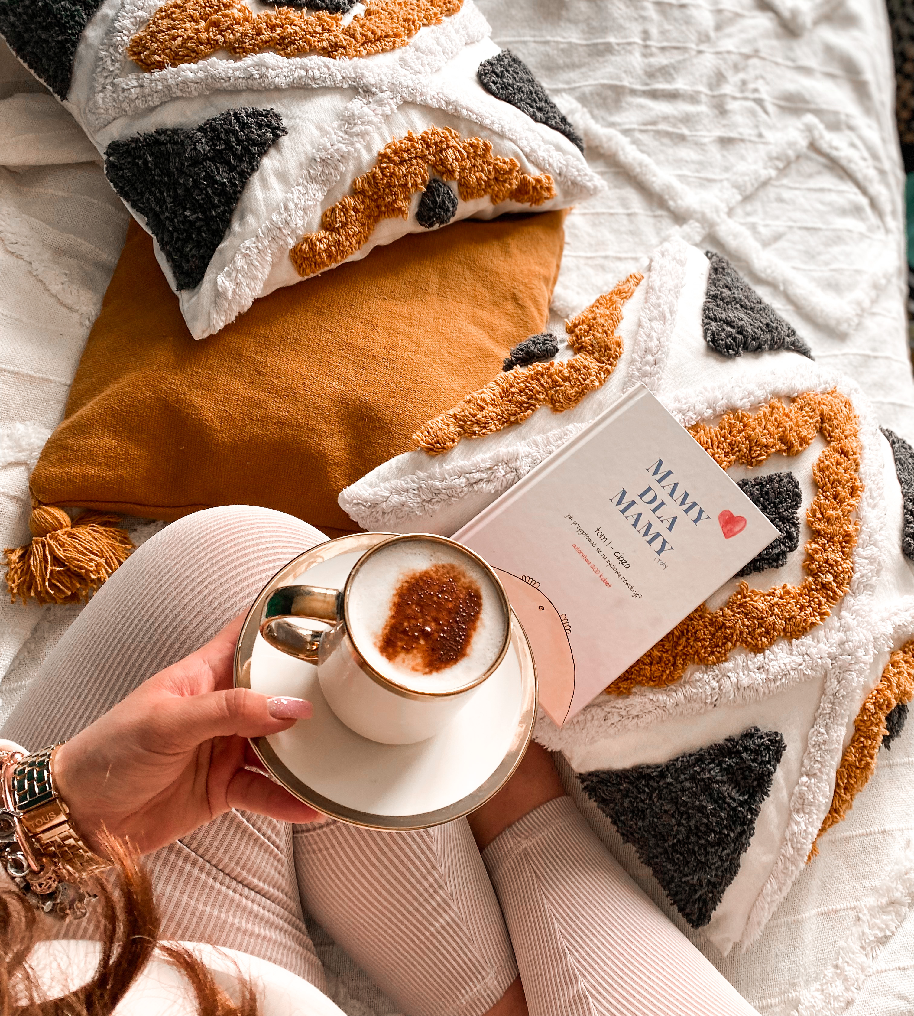 Coffee and the handbook on the bed