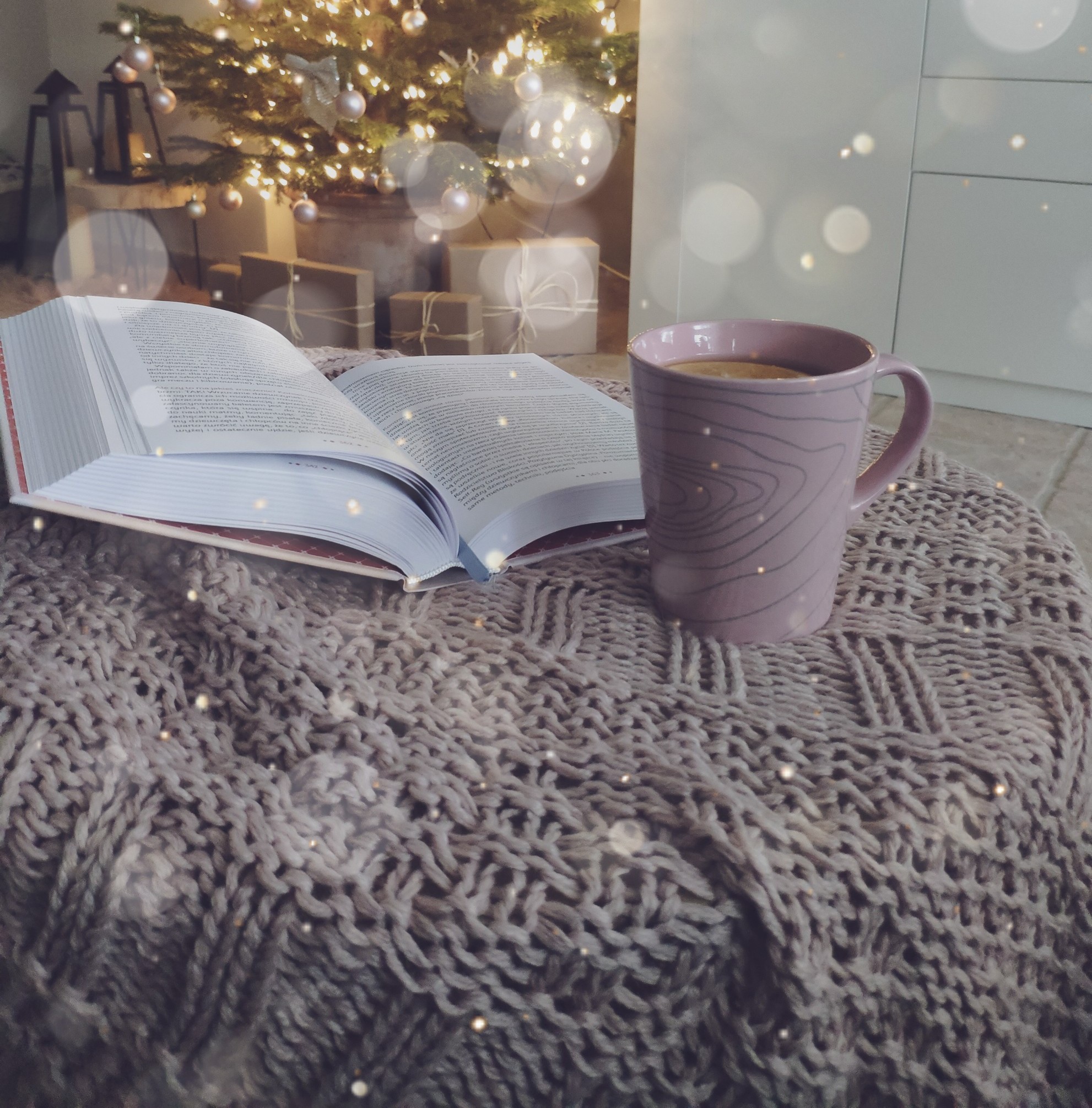 Open book and a mug by the tree