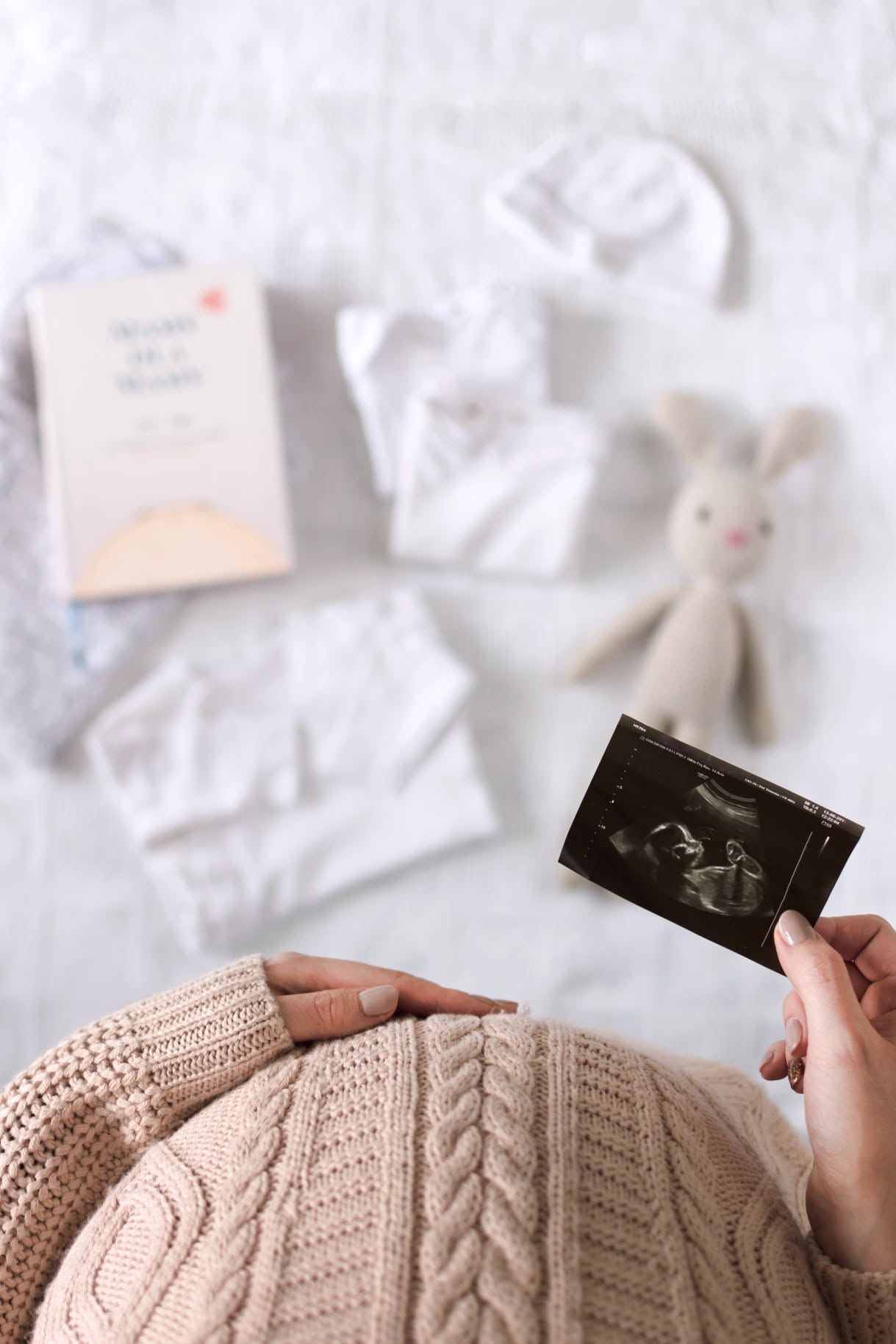 Bump, scan photo and the handbook on the bed
